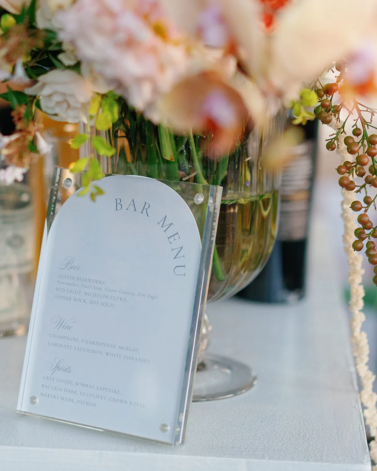 Huang–Dentino bar menu card on the bar cart, framed by peach and coral florals, Austin, TX