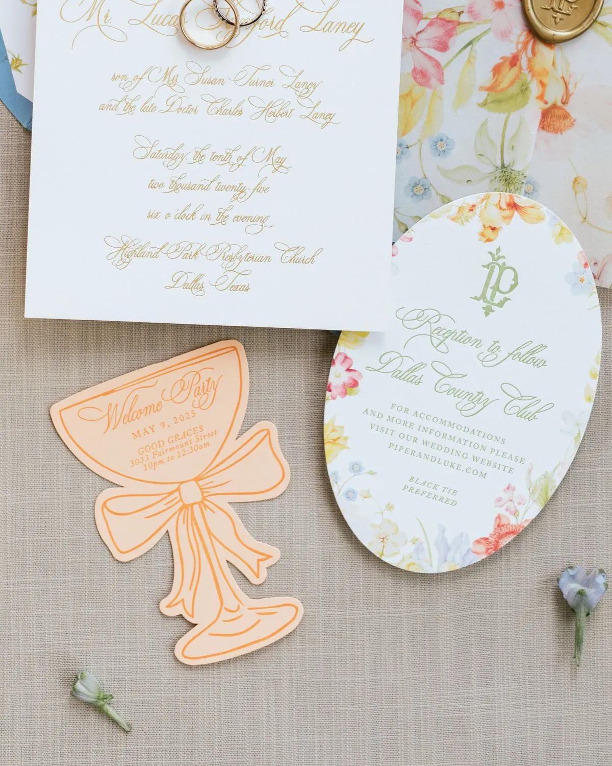 Laney die-cut welcome party card shaped as a bow, shown beside the oval reception card with a floral border
