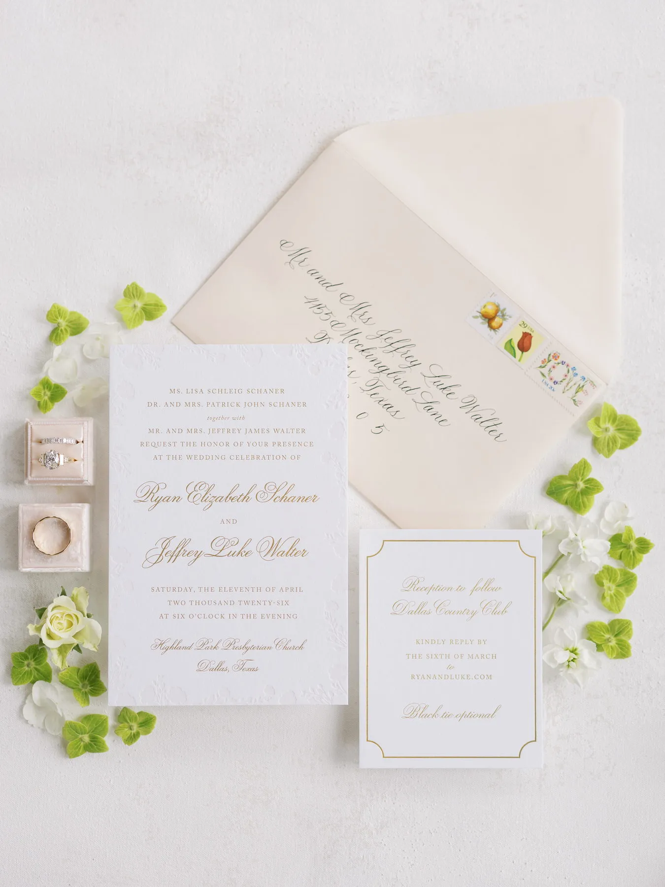 Walter suite: ivory letterpress invitation with a blind-embossed border, calligraphed envelope, vintage postage, white florals, and gold script